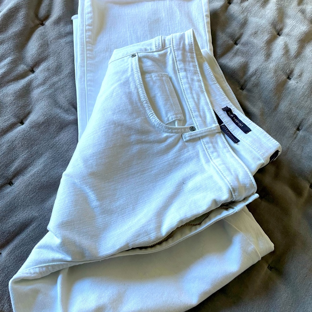 White straight leg lightly frayed hemmed jeans. Plus size